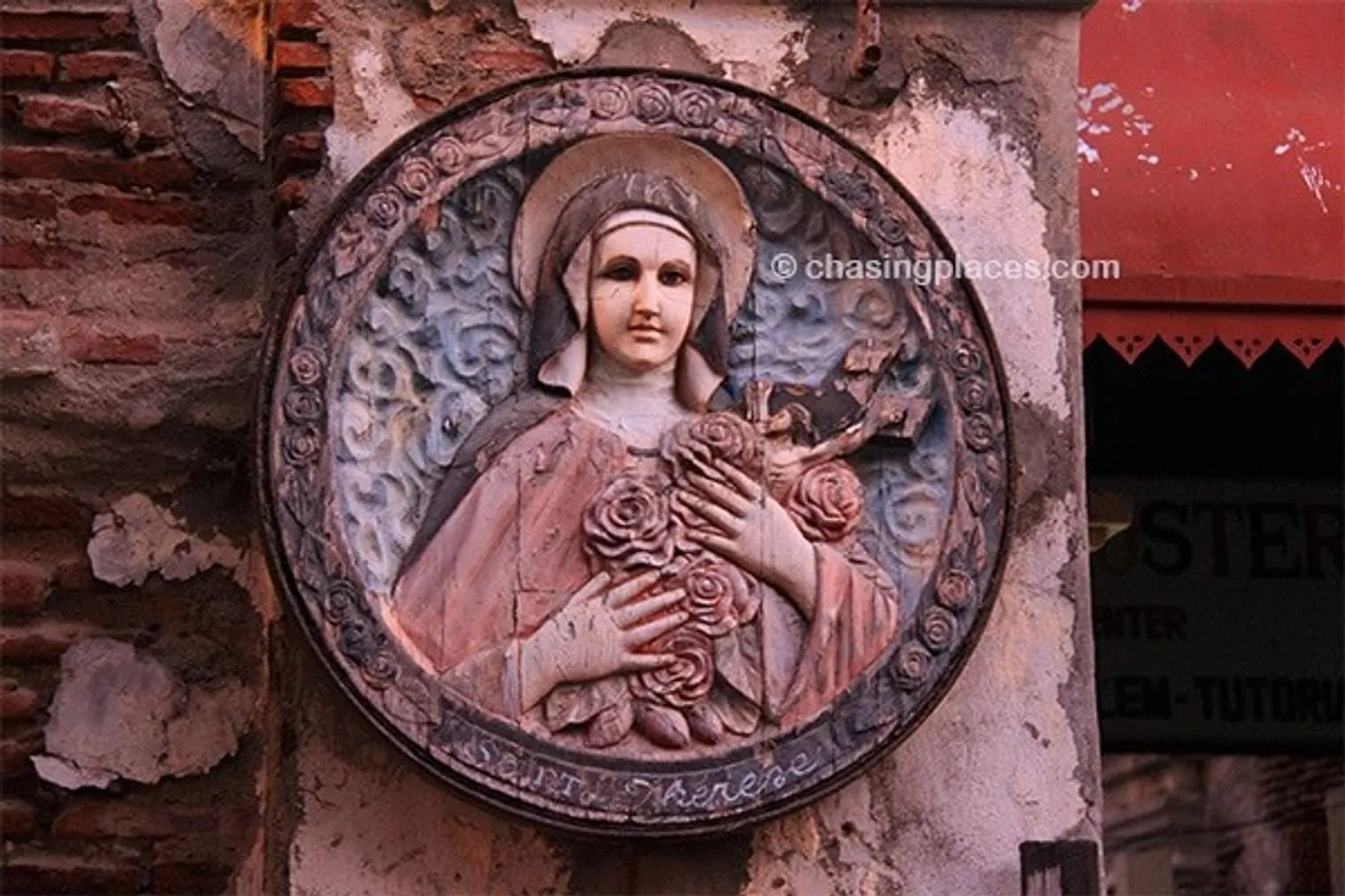 A beautiful wood carving covering up some aged cement in Vigan, Philippines