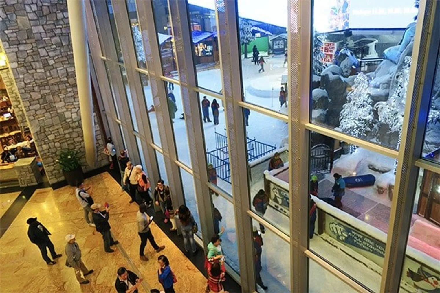 People from the outside looking in the indoor ski area