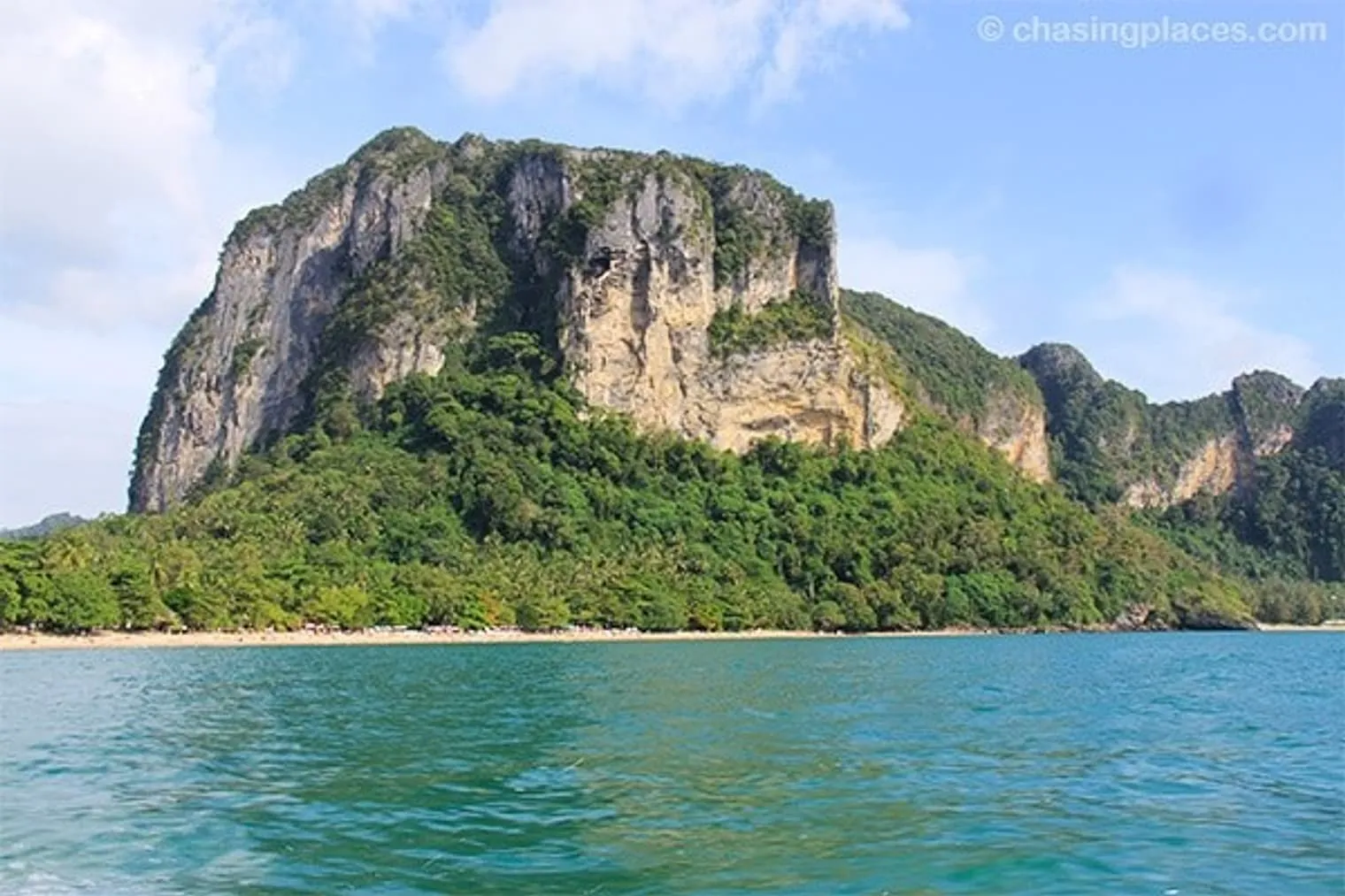 Ao Nang Beach transforming from golden sand to a stunning limestone face.