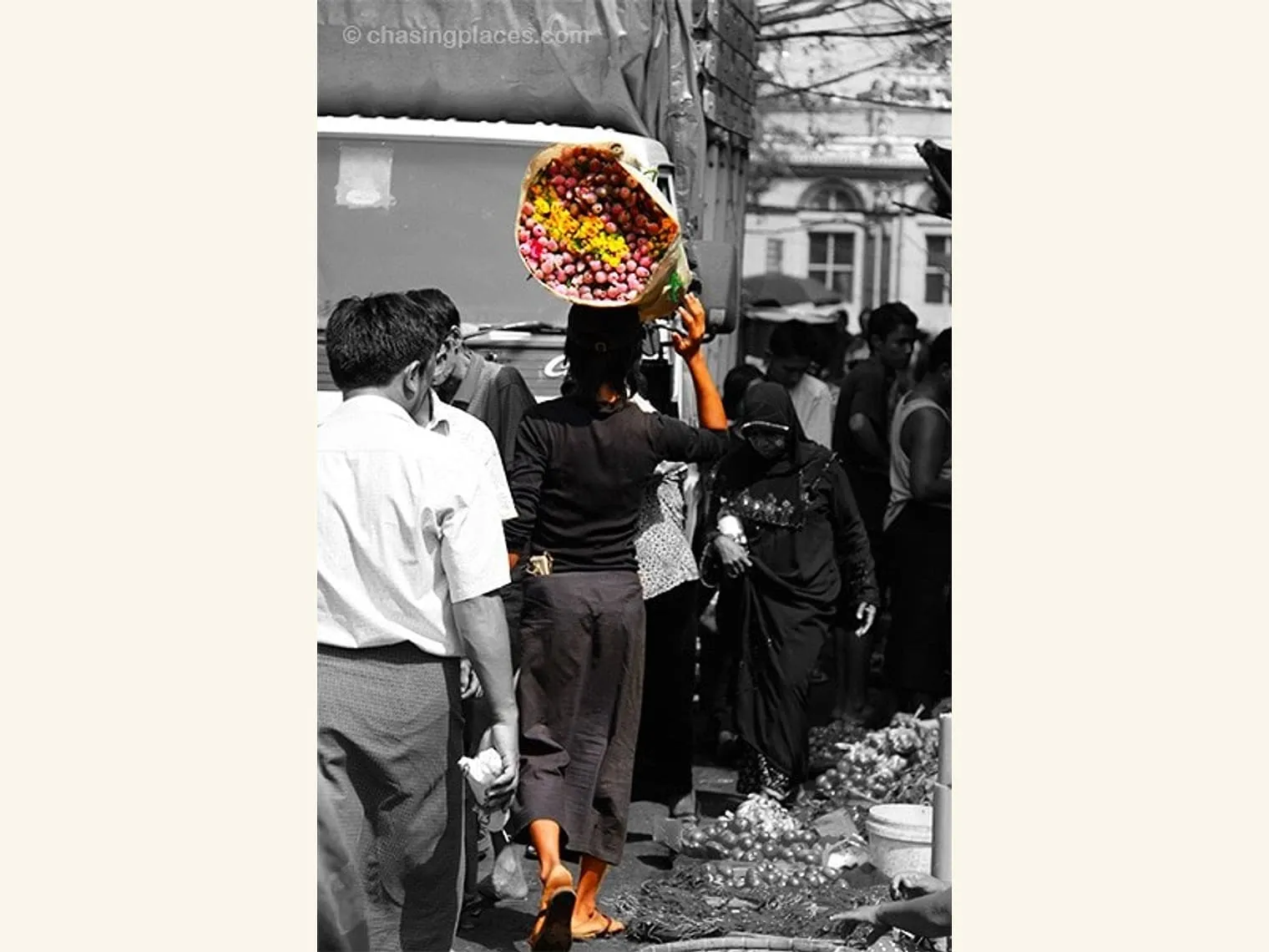 Without question, a lighter load. This middle aged woman navigates through this congested street moments away from Theingyi Zei Plaza in downtown Yangon.