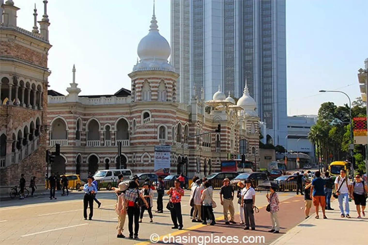 Tourists love walking around and and taking pictures of the buildings in Merdeka Square