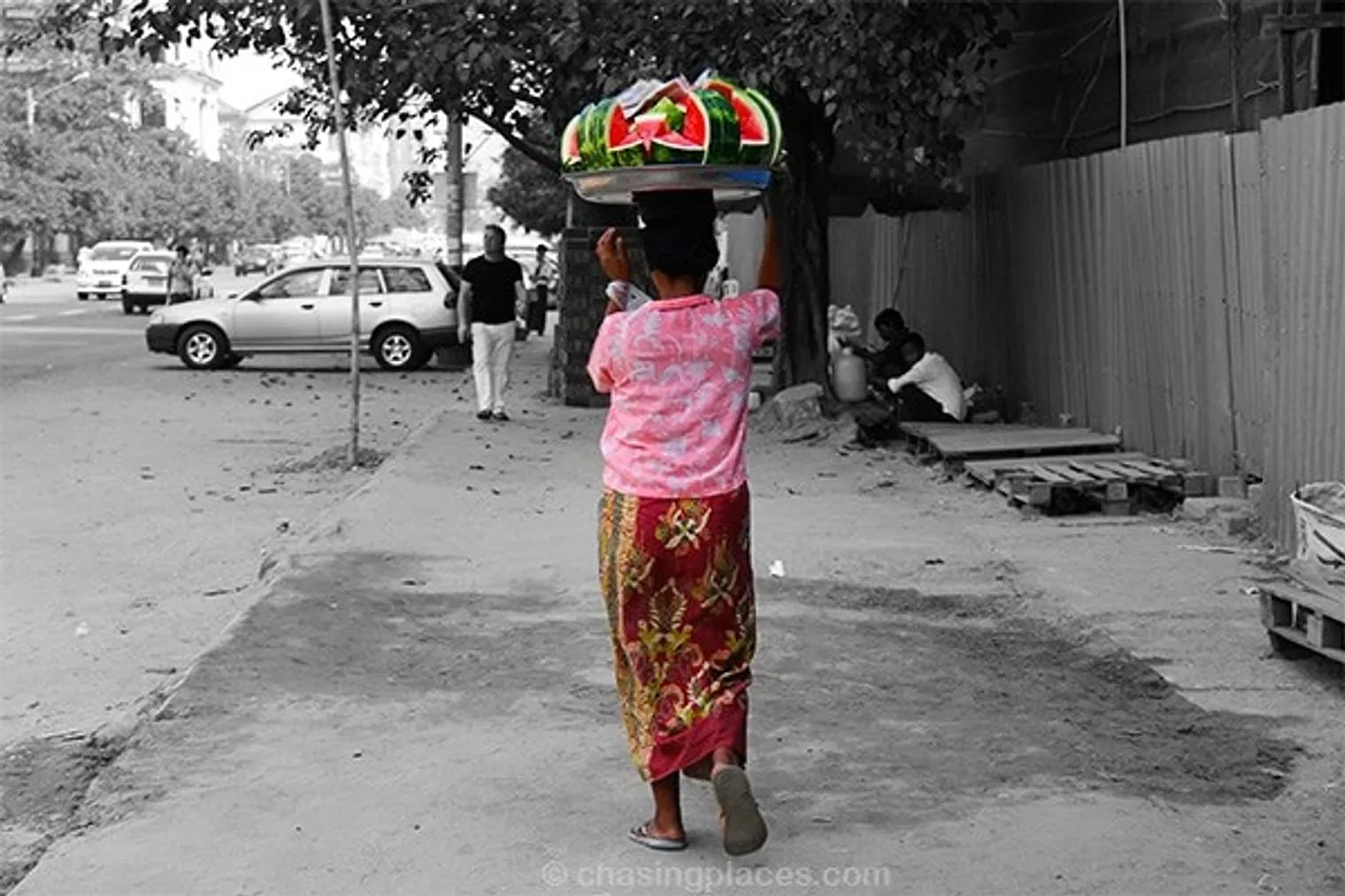 This beautifully dressed women moves briskly in the scorching sun to sell off her mouthwatering watermelon as quickly as possible. It tasted as good as it looks.